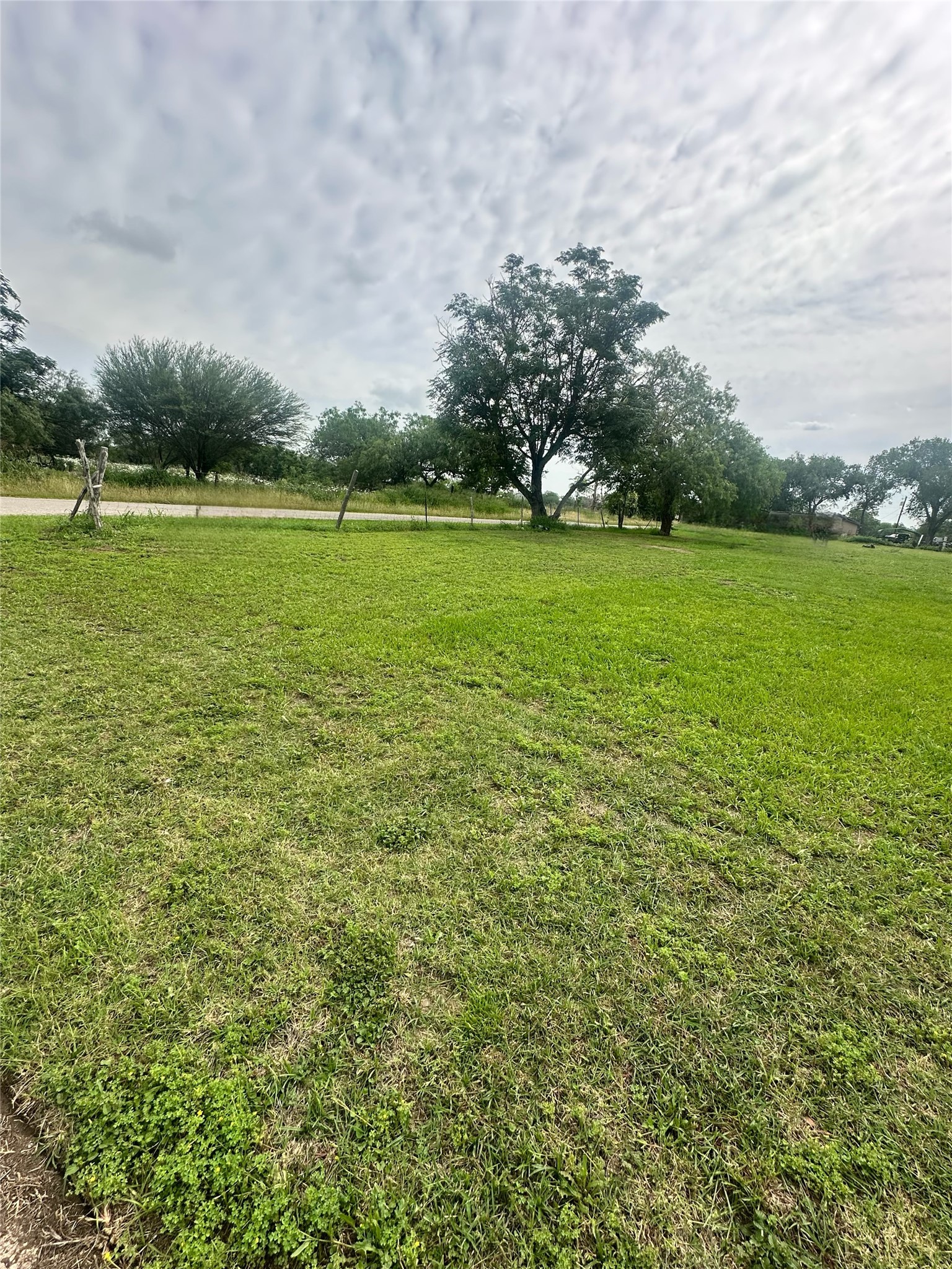 Tbd Fischer Street Cuero, TX 77954 - Photo 1 of 2 a view of a green field with wooden fence