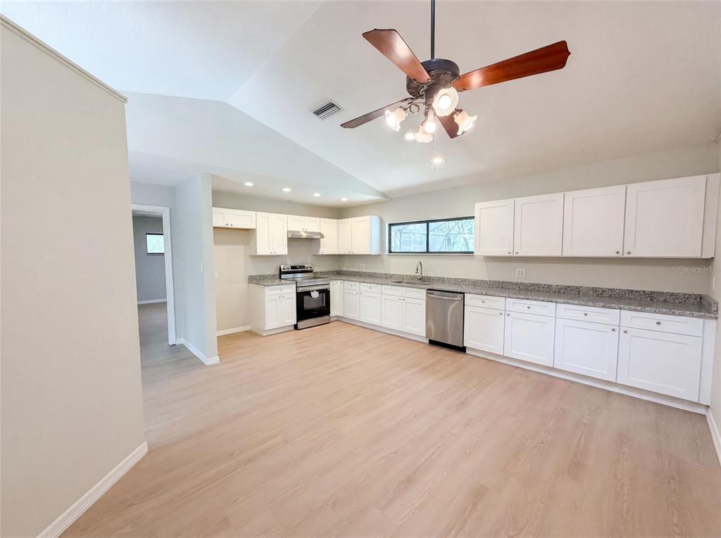 3739 Lake Griffin Road Lady Lake, FL 32159 - Photo 2 of 21 a view of a kitchen with a sink cabinets and stainless steel appliances