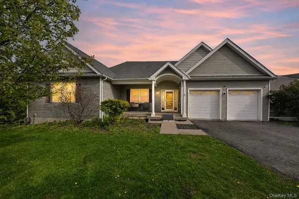 a front view of a house with patio and garden