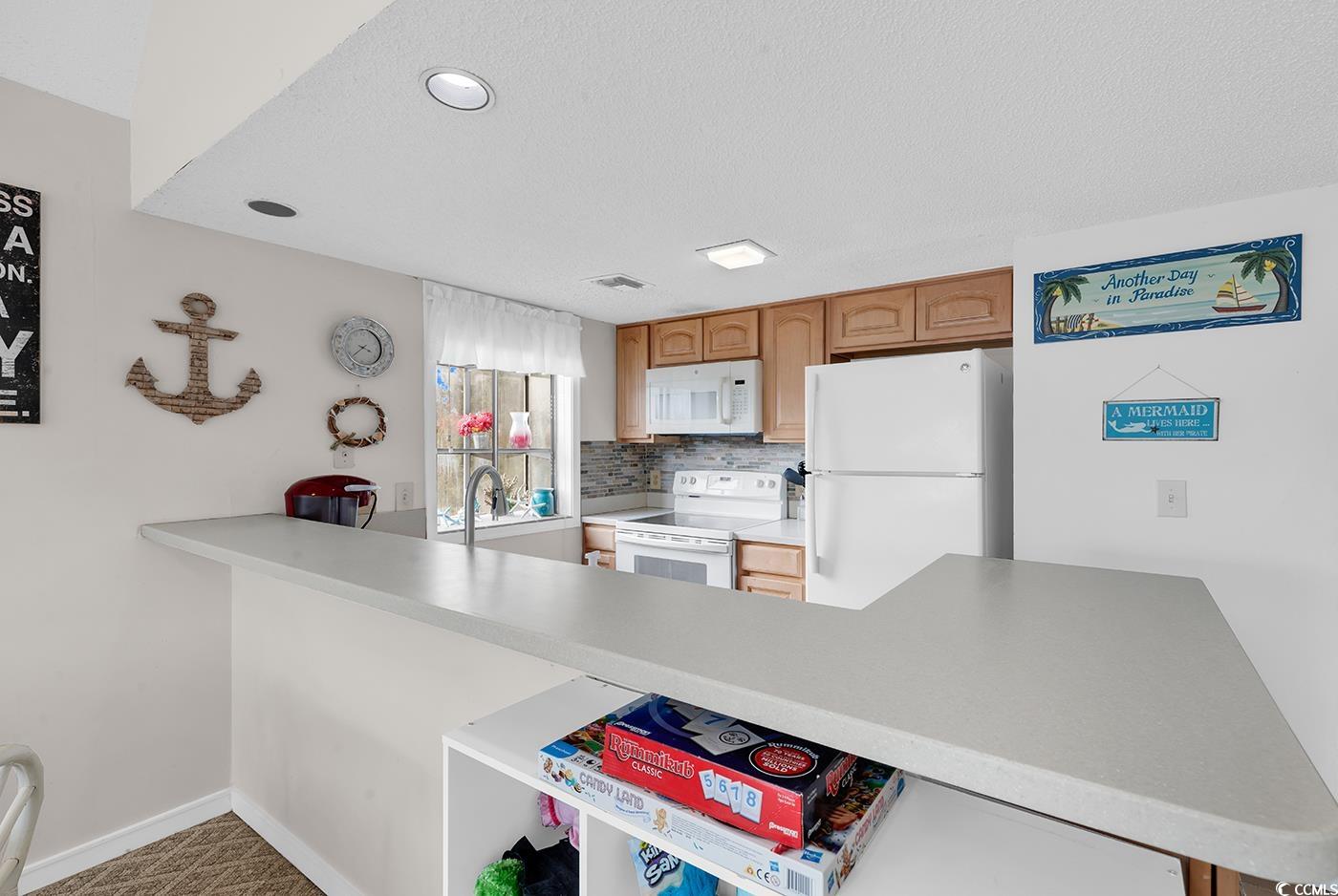 351 Lake Arrowhead Road, Unit 12347 Myrtle Beach, SC 29572 - Photo 5 of 36 Kitchen featuring tasteful backsplash, light count