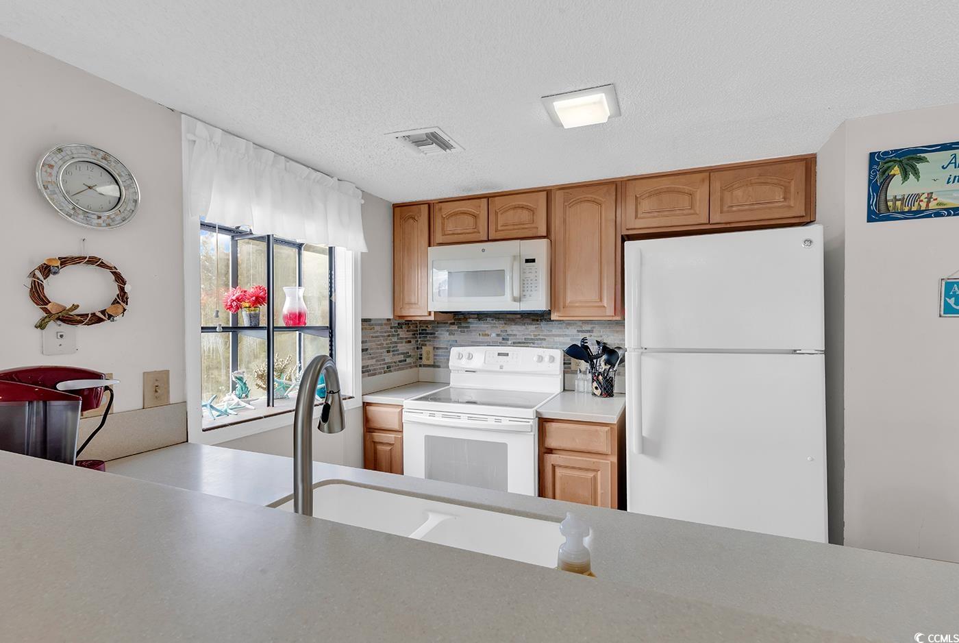 351 Lake Arrowhead Road, Unit 12347 Myrtle Beach, SC 29572 - Photo 6 of 36 Kitchen featuring light countertops, visible vents