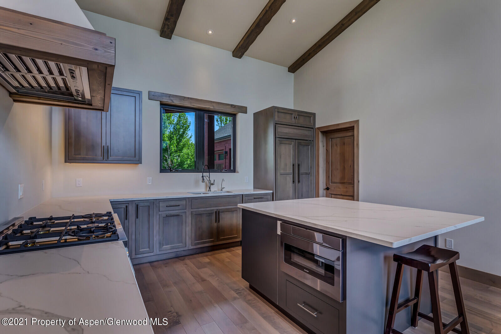 471 Boundary Lane Carbondale, CO 81623 - Photo 10 of 30 a kitchen with sink a stove and wooden floor