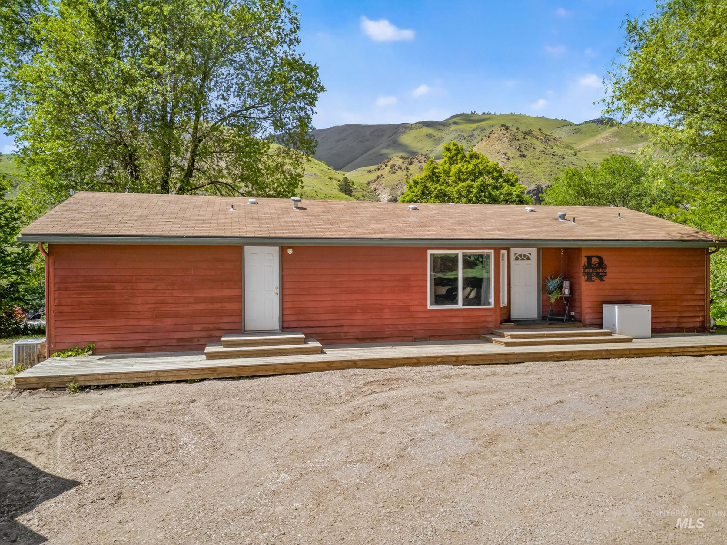 151 Cow Creek Road Lucile, ID 83542 - Photo 5 of 50 Red siding exterior with a brown shingle roof