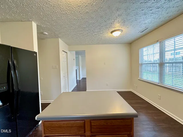 an empty room with wooden floor and a window