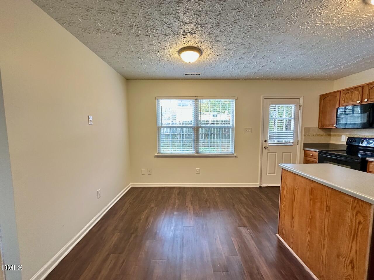 4232 Palafox Court Raleigh, NC 27604 - Photo 12 of 28 an empty room with wooden floor and a window
