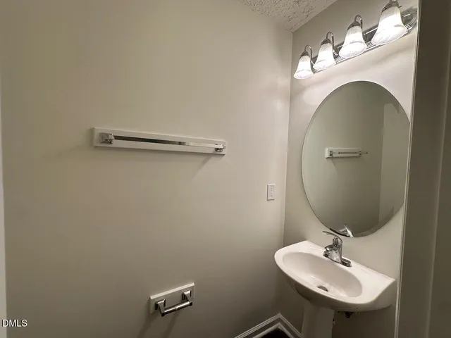 an empty room with wooden floor chandelier fan and windows