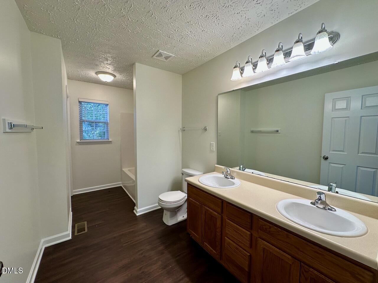 4232 Palafox Court Raleigh, NC 27604 - Photo 17 of 28 a bathroom with a sink vanity and a mirror