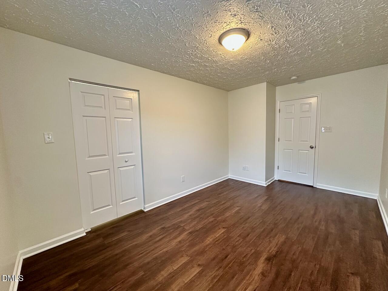 4232 Palafox Court Raleigh, NC 27604 - Photo 21 of 28 a view of an empty room with wooden floor