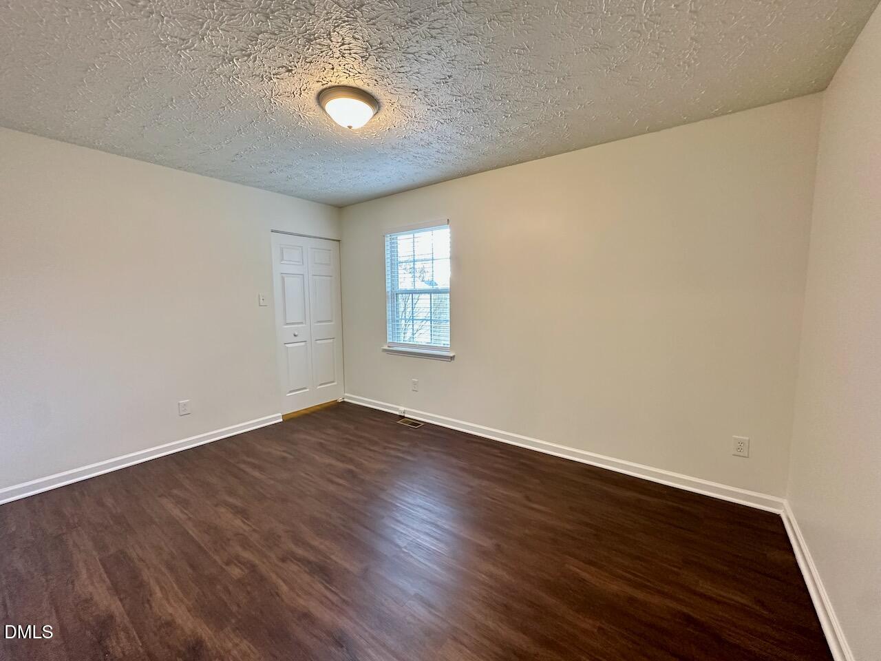 4232 Palafox Court Raleigh, NC 27604 - Photo 24 of 28 an empty room with wooden floor and windows