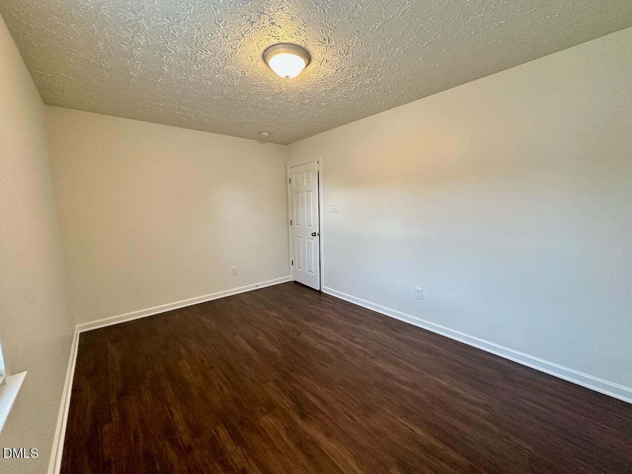 4232 Palafox Court Raleigh, NC 27604 - Photo 25 of 28 a view of an empty room with wooden floor
