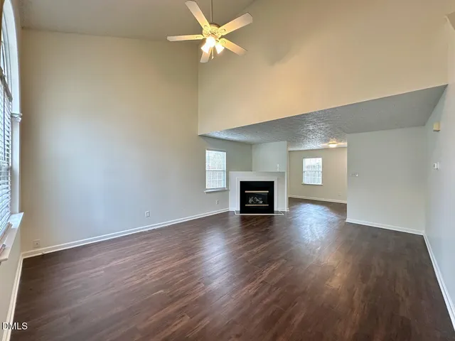 wooden floor in an empty room with a fireplace