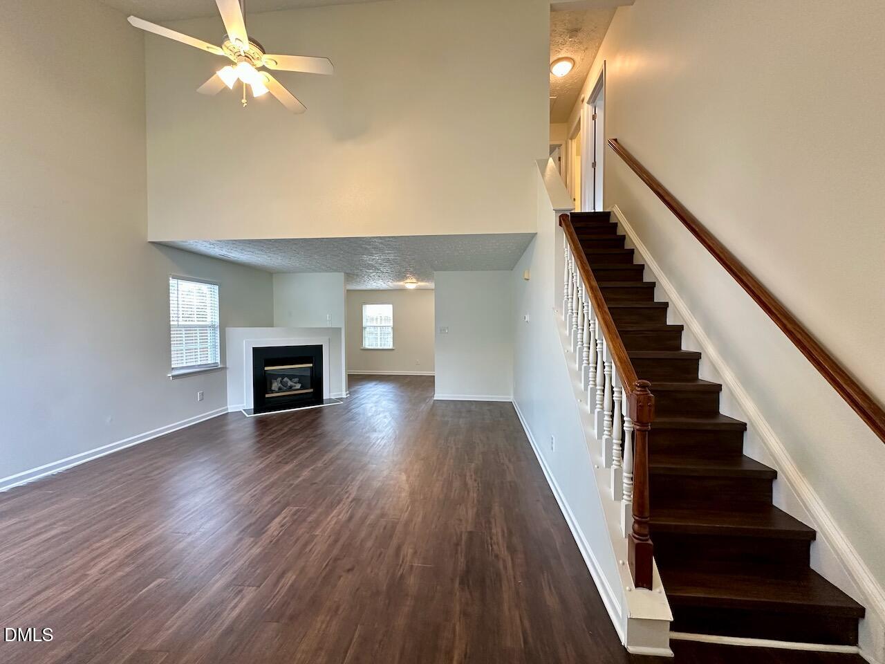 4232 Palafox Court Raleigh, NC 27604 - Photo 5 of 28 wooden floor in an empty room with a fireplace
