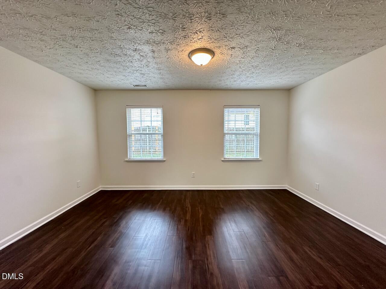 4232 Palafox Court Raleigh, NC 27604 - Photo 7 of 28 an empty room with wooden floor and windows