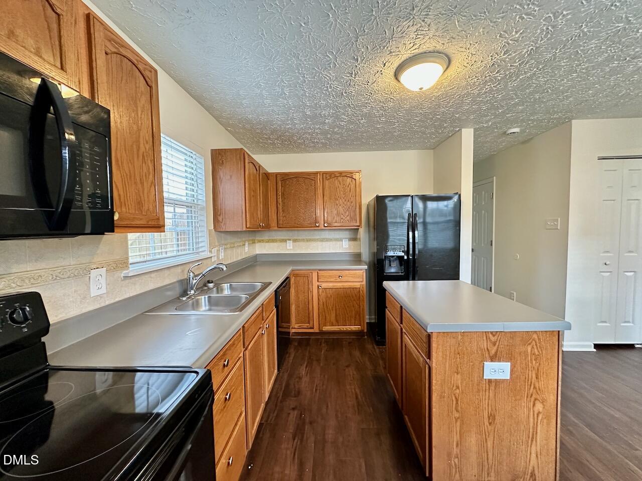 4232 Palafox Court Raleigh, NC 27604 - Photo 10 of 28 a kitchen with stainless steel appliances granite countertop a sink refrigerator and microwave