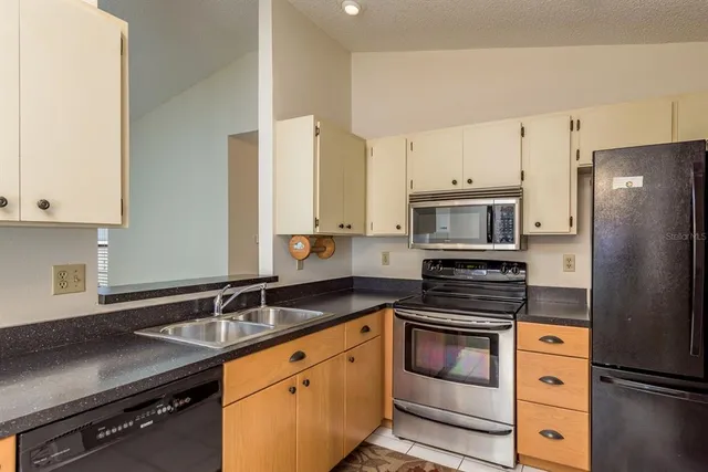 a kitchen with a sink stove and refrigerator