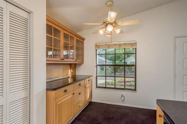 a view of kitchen with cabinets and wooden floor