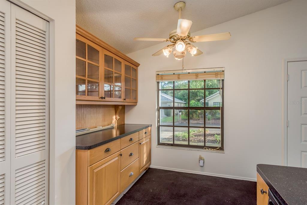 10918 Freemont Drive New Port Richey, FL 34654 - Photo 13 of 26 a view of kitchen with cabinets and wooden floor