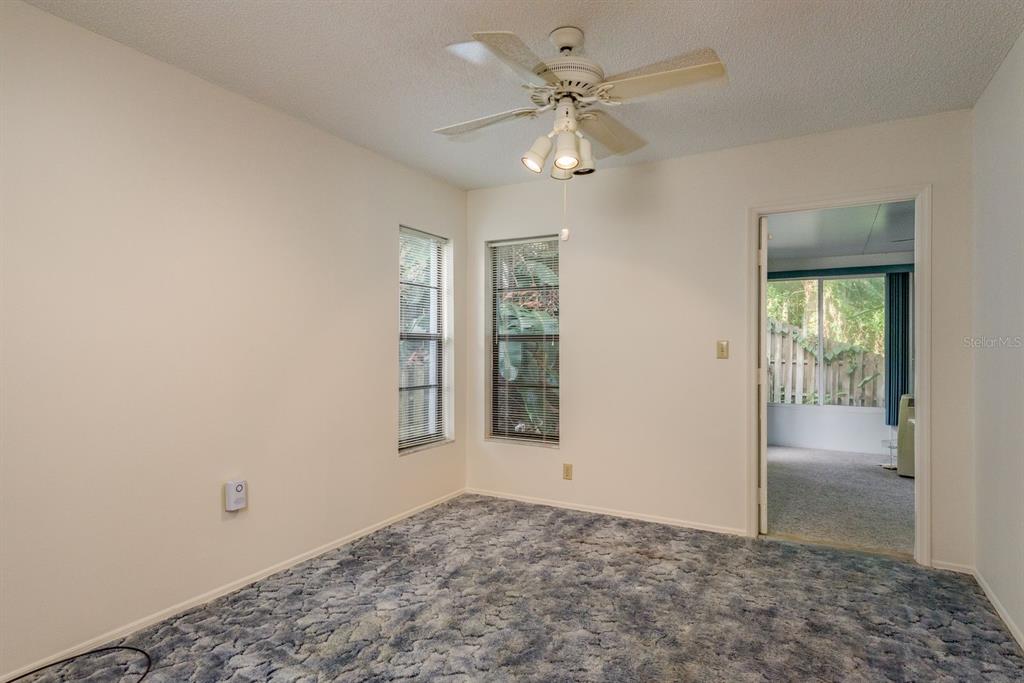 10918 Freemont Drive New Port Richey, FL 34654 - Photo 14 of 26 an empty room with fan and windows