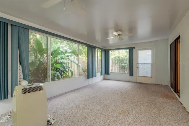 a view of an empty room with a fireplace and a large window