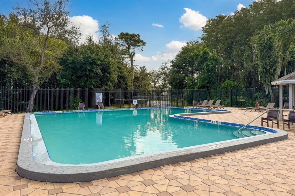 10918 Freemont Drive New Port Richey, FL 34654 - Photo 25 of 26 a view of a swimming pool with a sitting space