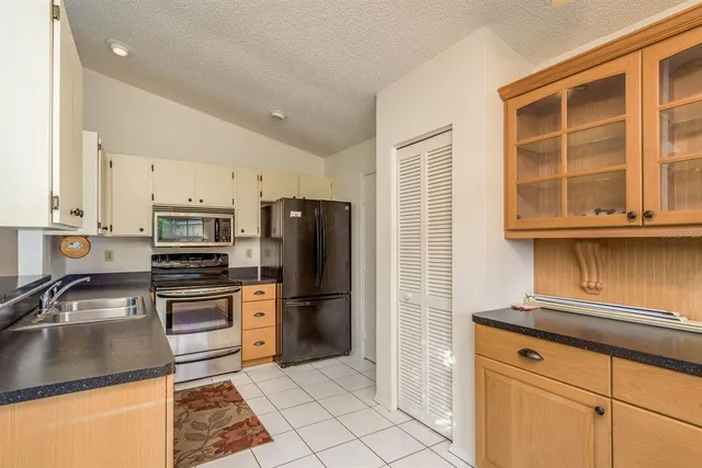 a kitchen with a refrigerator stove and sink