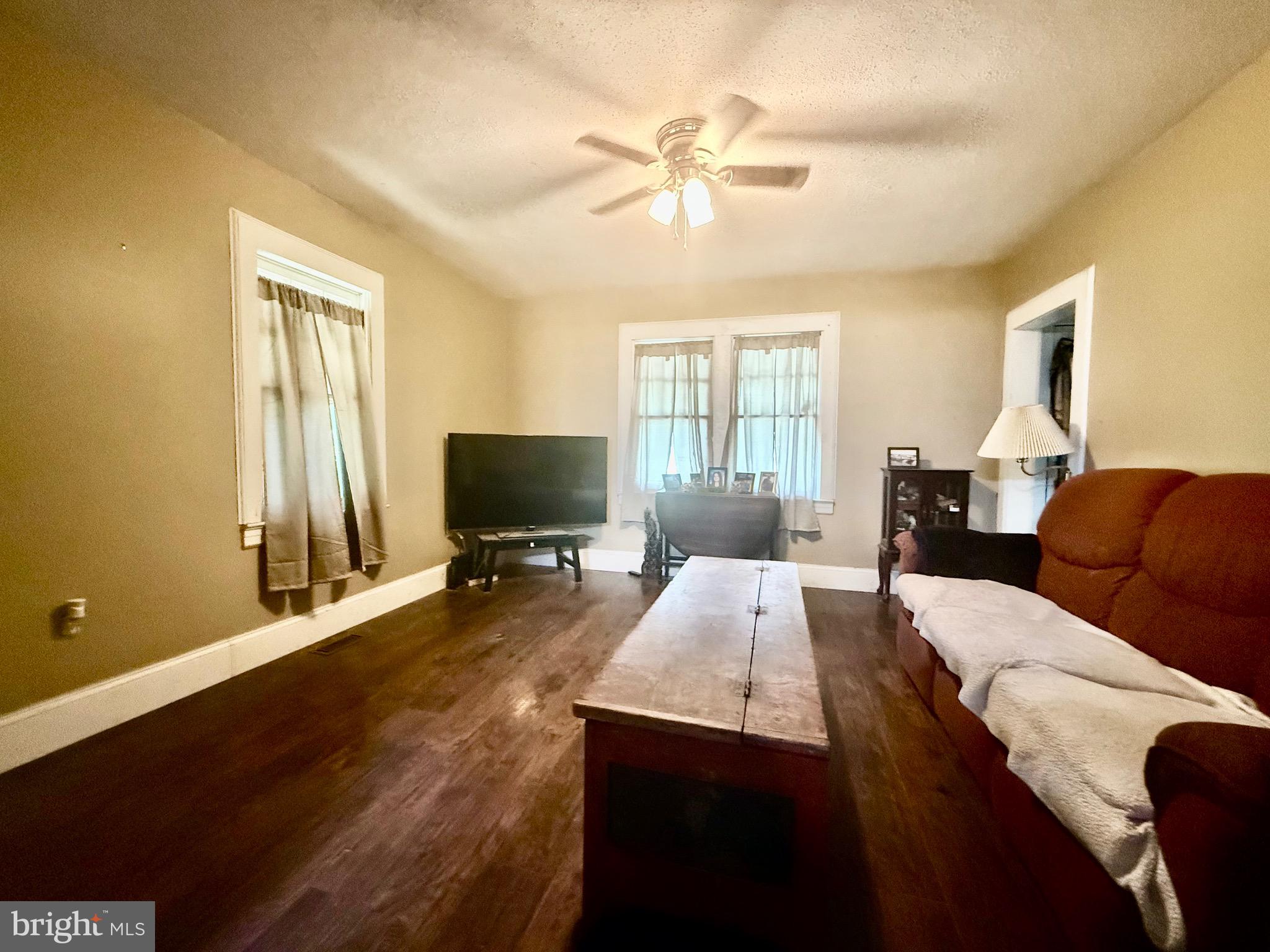 9860 H G Trueman Road Lusby, MD 20657 - Photo 5 of 12 a living room with furniture and a flat screen tv