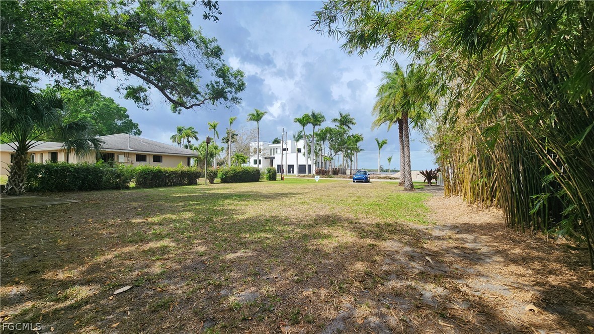 4528 East Riverside Drive Fort Myers, FL 33905 - Photo 2 of 13 a view of a tree in front of a house