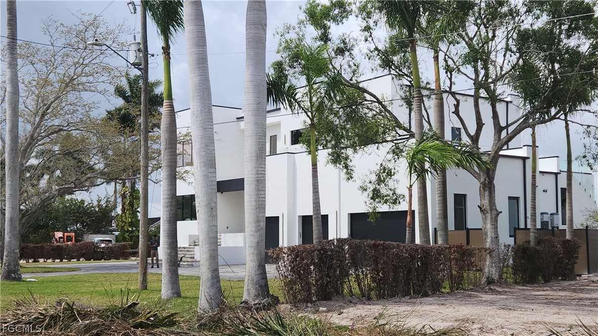 4528 East Riverside Drive Fort Myers, FL 33905 - Photo 3 of 13 a tree in front of a building