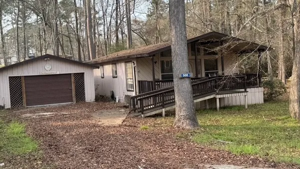 a view of a house with a yard and roof