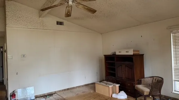 a living room with a chair and a fireplace