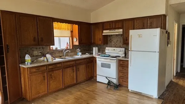 a kitchen with a refrigerator sink stove and cabinets