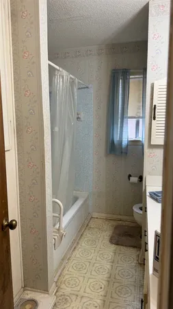 a bathroom with a shower and a toilet