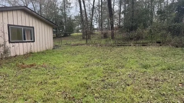 a backyard of a house with lots of green space