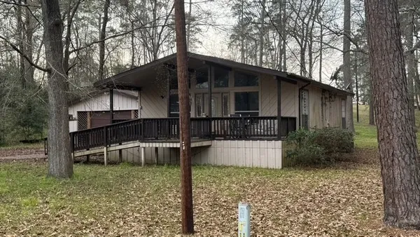 a house that has a tree in front of it