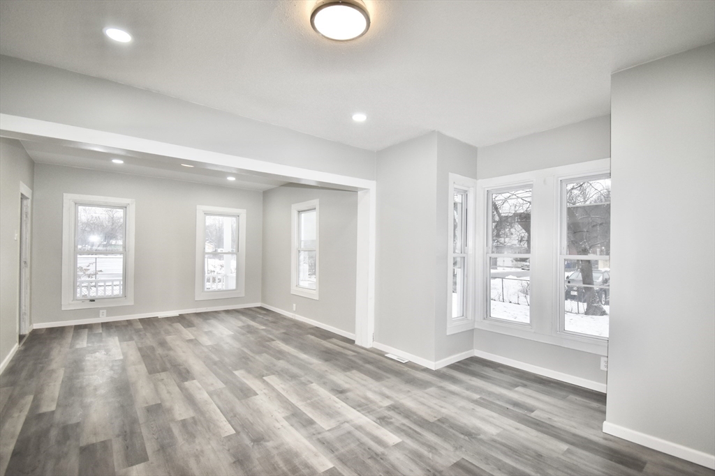 36 Orleans Street Springfield, MA 01109 - Photo 1 of 32 a view of an empty room with window and wooden floor