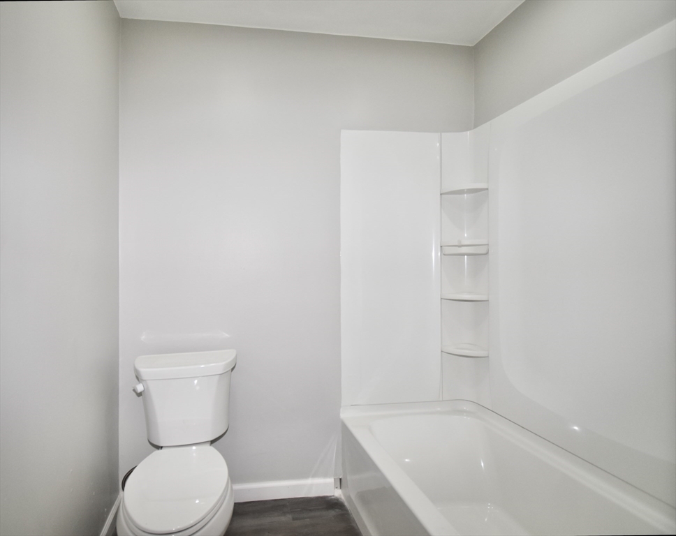 36 Orleans Street Springfield, MA 01109 - Photo 13 of 32 a white toilet sitting next to a bath tub