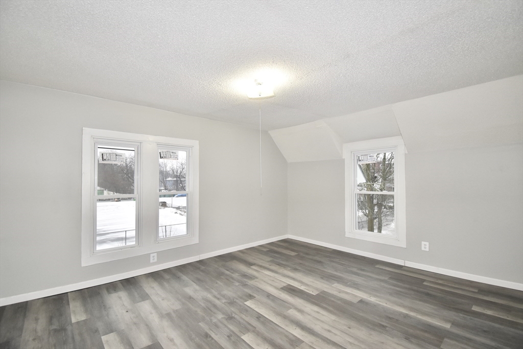 36 Orleans Street Springfield, MA 01109 - Photo 16 of 32 an empty room with wooden floor and windows