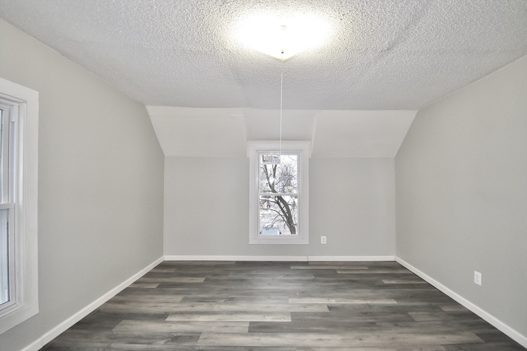 36 Orleans Street Springfield, MA 01109 - Photo 17 of 32 an empty room with wooden floor and windows