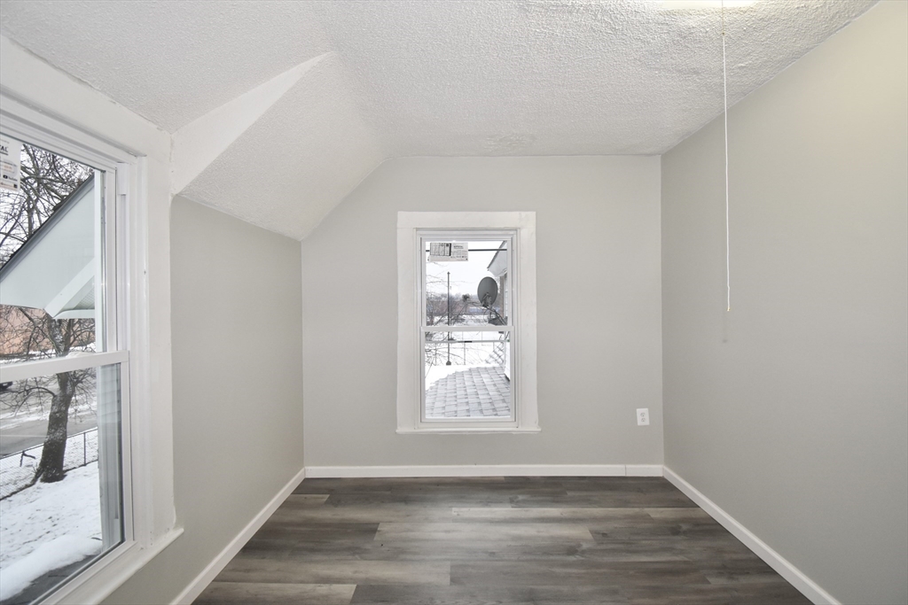 36 Orleans Street Springfield, MA 01109 - Photo 20 of 32 a view of an empty room with wooden floor and a window