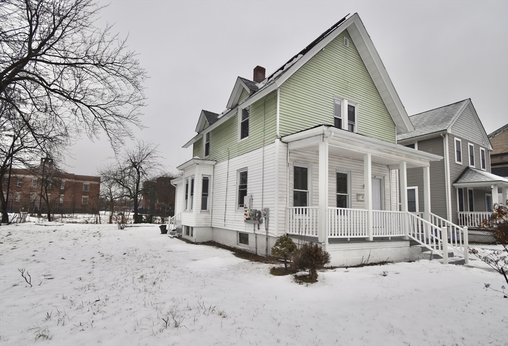 36 Orleans Street Springfield, MA 01109 - Photo 23 of 32 a front view of a house with a yard covered in snow