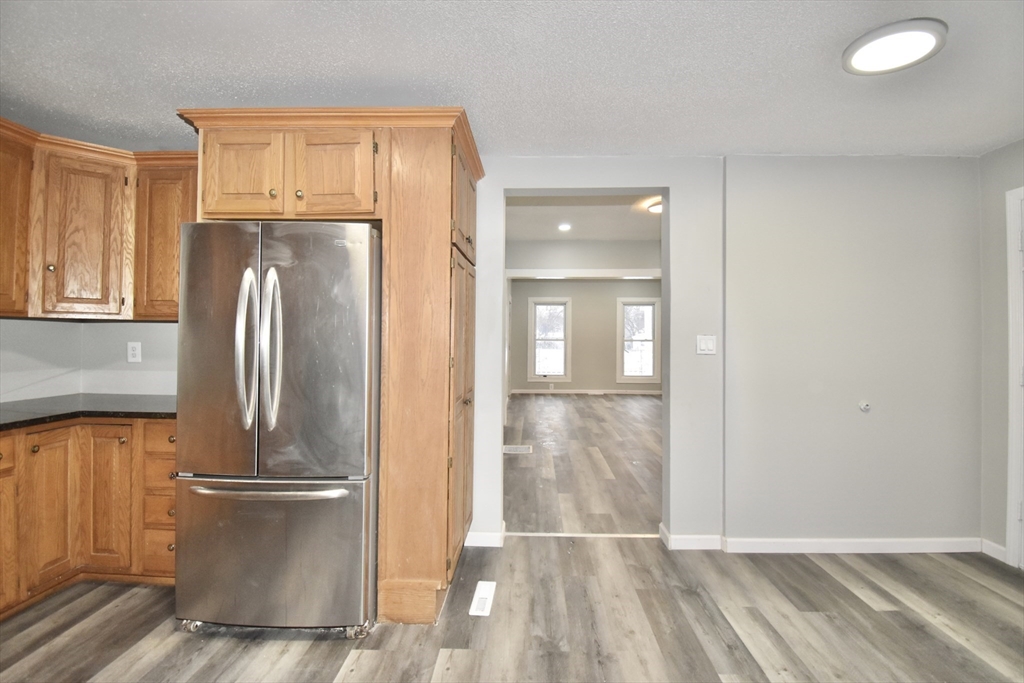 36 Orleans Street Springfield, MA 01109 - Photo 10 of 32 a view of a refrigerator in kitchen and wooden floor