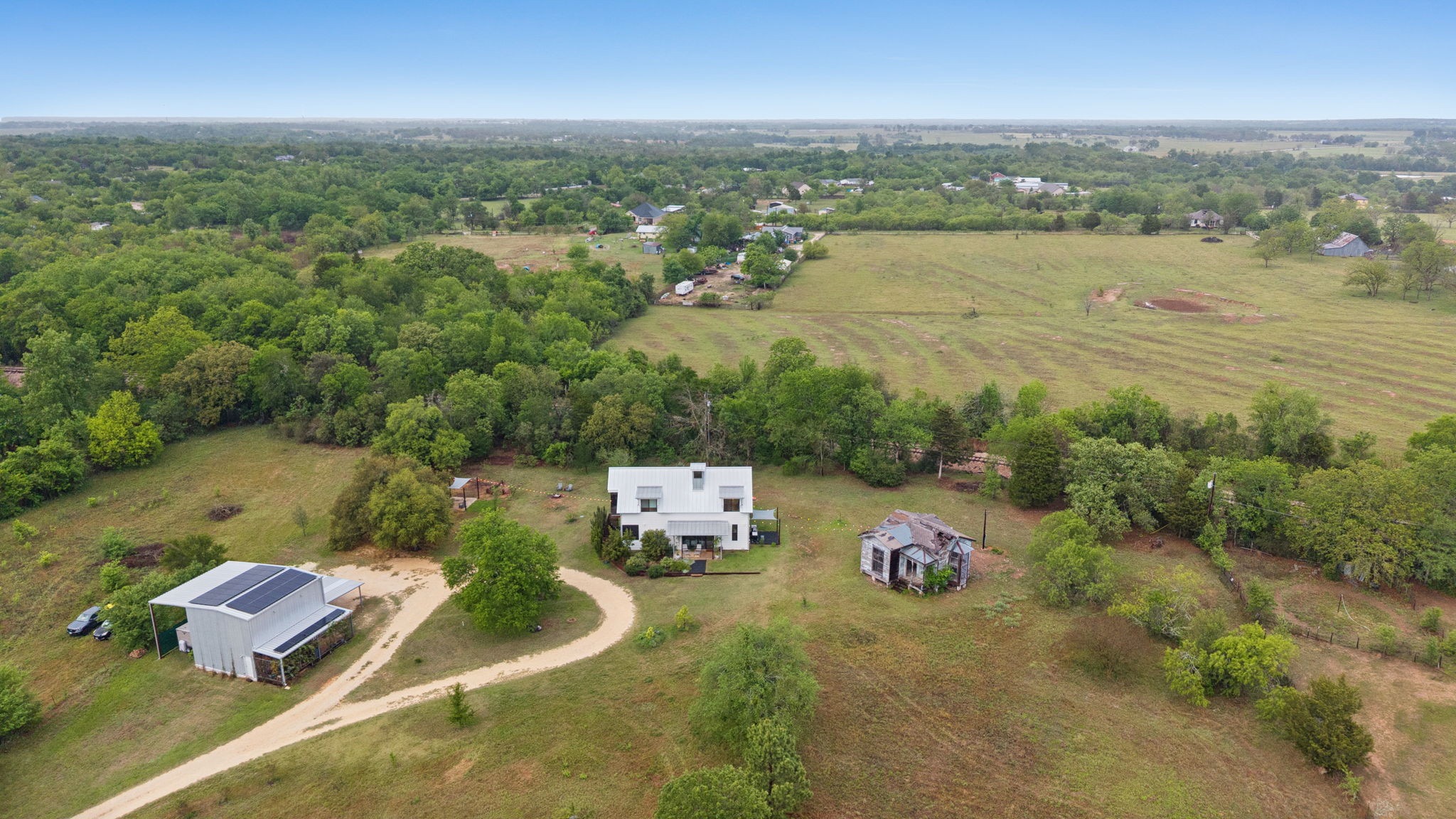 534 Old McDade Road Elgin, TX 78621 - Photo 3 of 40 Aerial view of house, workshop and Victorian house. Six acres of private living inside Elgin city limits.