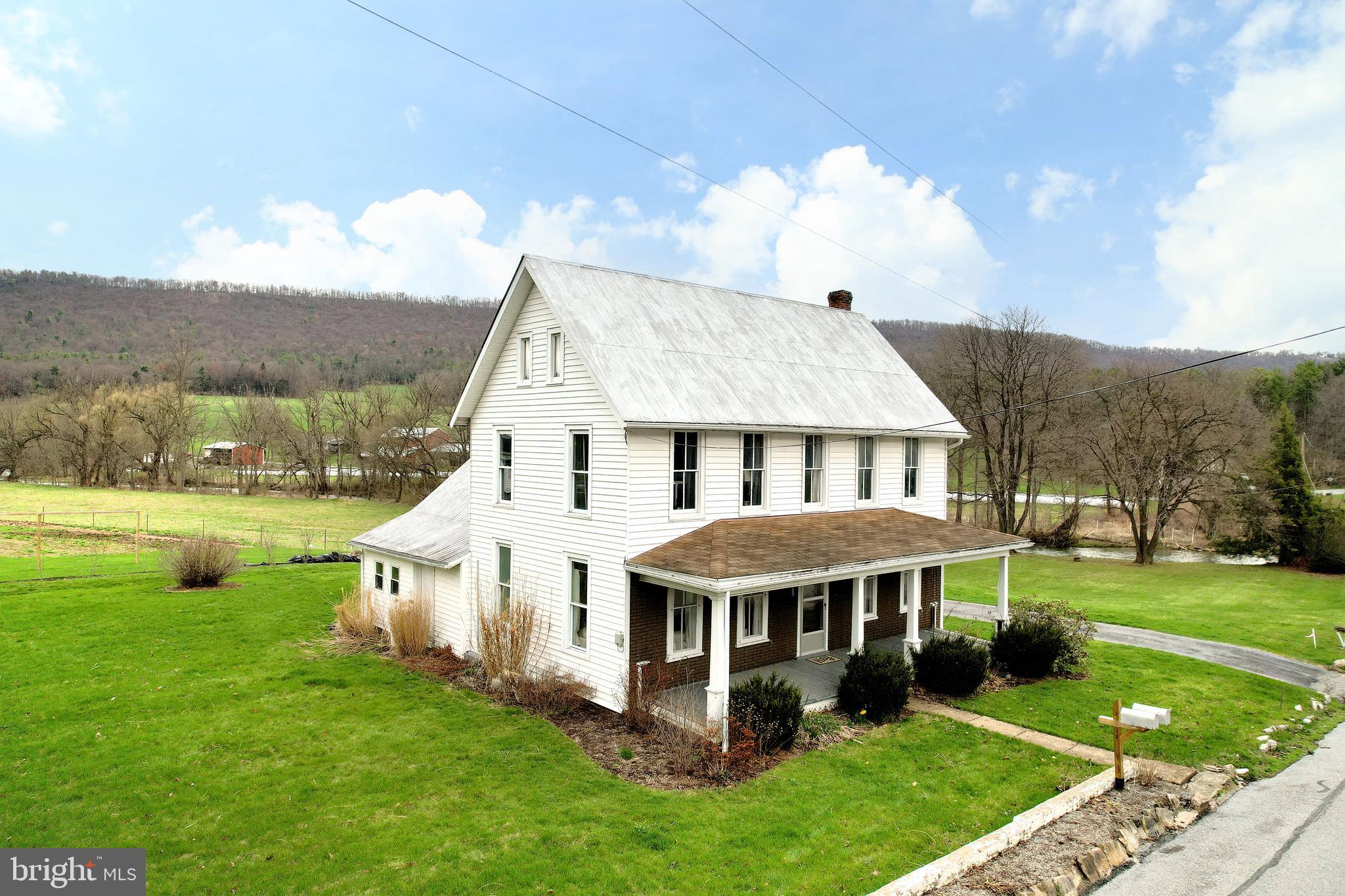 a aerial view of a house with yard and green space