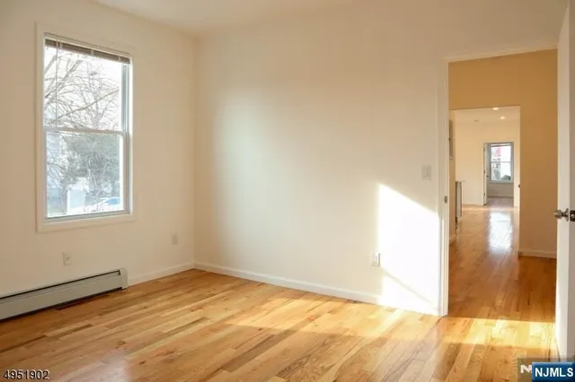 a view of a room with wooden floor
