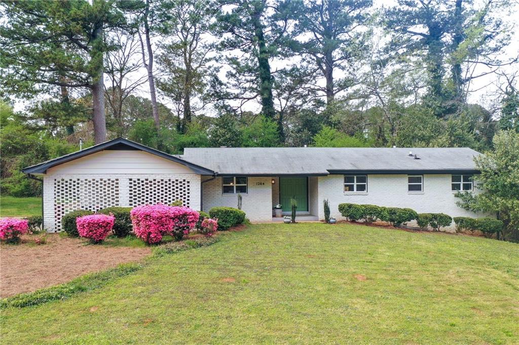 1264 Berkeley Road Avondale Estates, GA 30002 - Photo 1 of 1 a front view of a house with garden
