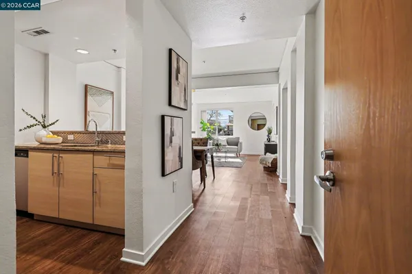 a kitchen with cabinets and wooden floor