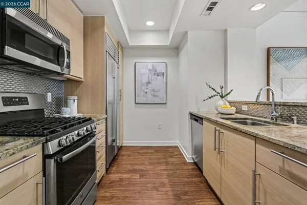a kitchen with stainless steel appliances granite countertop a stove and a microwave