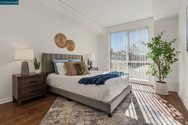 a bed sitting in a bedroom next to a window