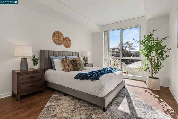 a bed room with a bed and a potted plant