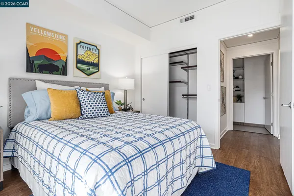 a bedroom with bed and painting on the wall